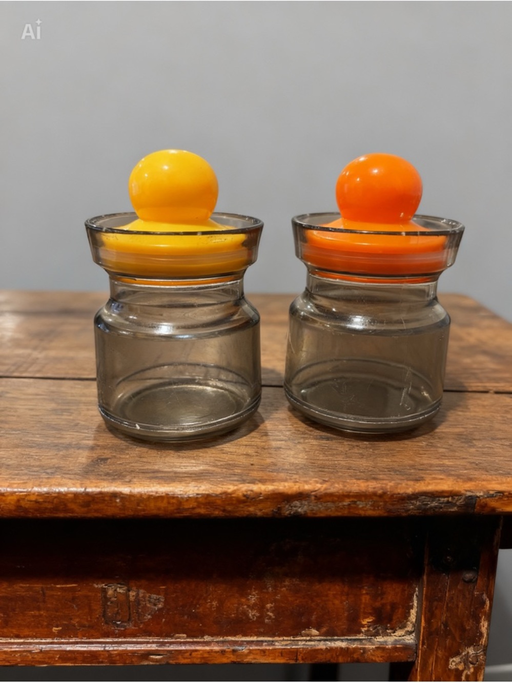 Set of Two Plastic Spice Knob Jars with Yellow and Orange Lids